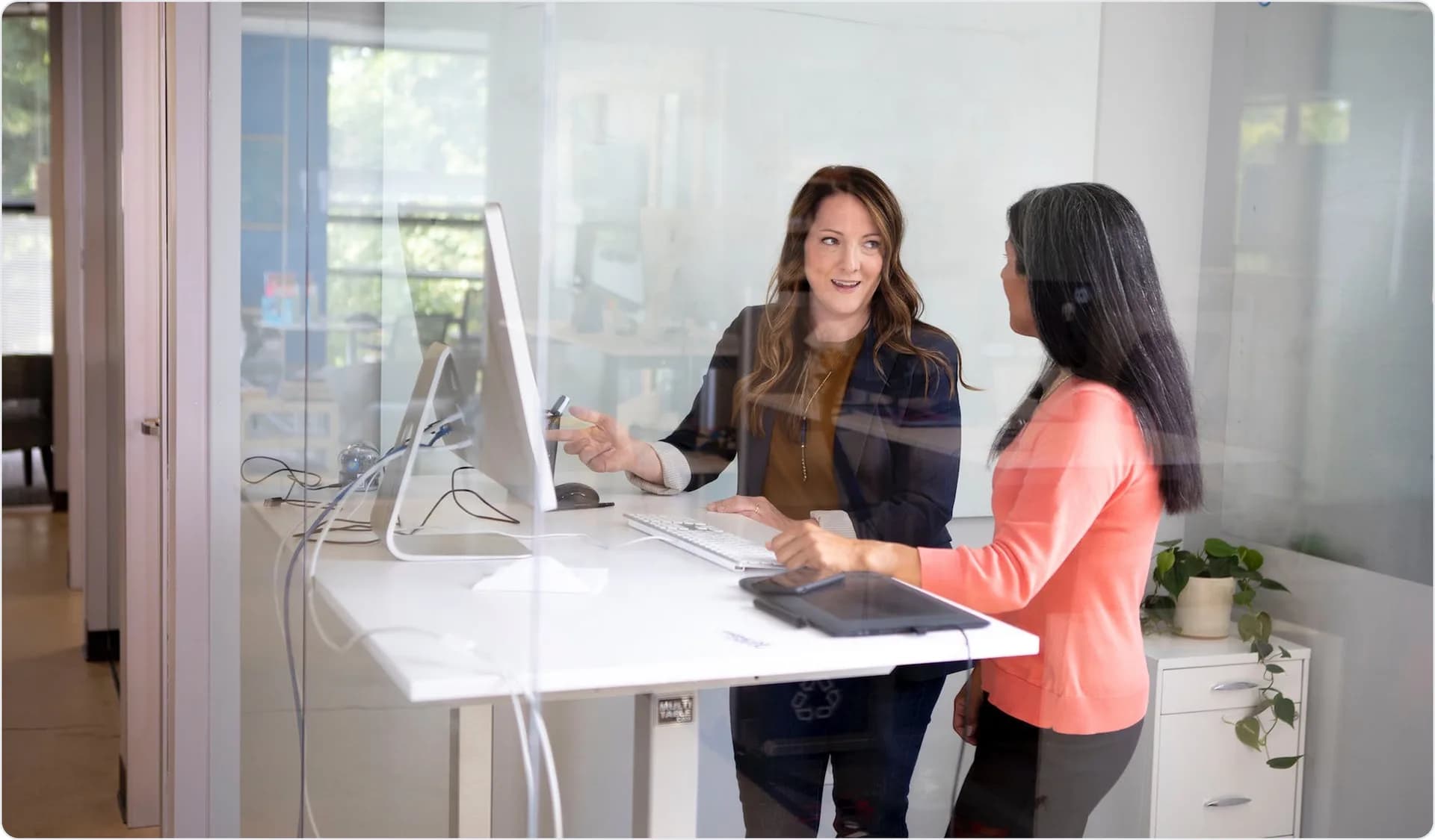 Two colleagues collaborating at desk